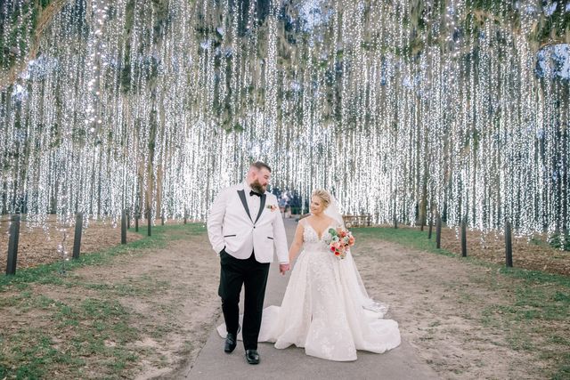 Featured photo from Celebrate This Storybook Wedding at Brookgreen Gardens with Illuminated Trees and Bold Florals