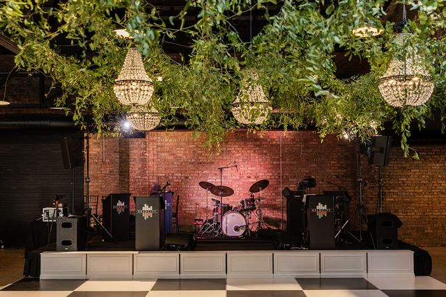 Featured photo from Experience This Revel Motor Row Wedding Highlighting Crystal Chandeliers and a Statement Band Stage