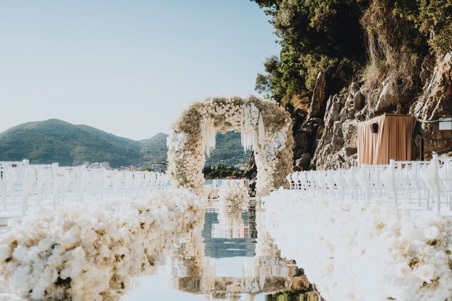 Featured photo from Explore This Waterfront Wedding in Budva, Montenegro Framed by Sculptural Florals and a Floating Aisle