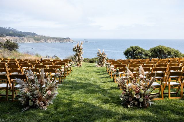 Featured photo from Step Into This Coastal Wedding Featuring Aisle-Set Wooden Seating and Layered Cliffside Floral Design