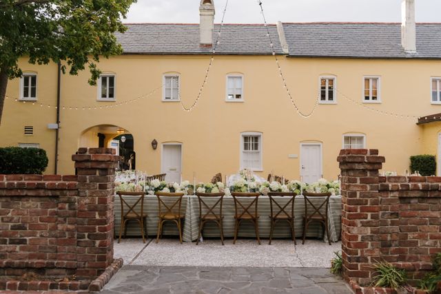 Featured photo from Explore This Courtyard Wedding Defined by Soft Green Palettes and Candle Glow at William Aiken House